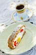 Photo: A slice of wholemeal sponge cake, filled with quark cream, mango and strawberries with a cup of mocha in the background A slice of wholemeal sponge cake, filled with quark cream, mango and strawberries with a cup of mocha in the background
