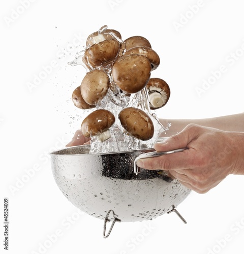 Photo: Brown mushrooms being washed in a sieve Brown mushrooms being washed in a sieve