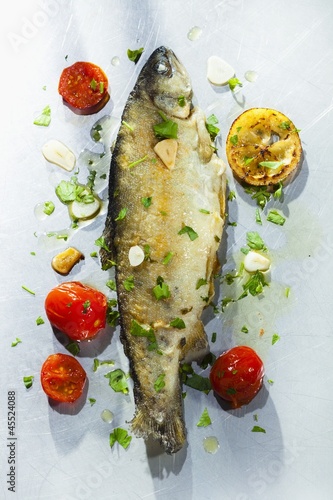 Photo: Fried trout with herbs, garlic, tomatoes and lemons Fried trout with herbs, garlic, tomatoes and lemons