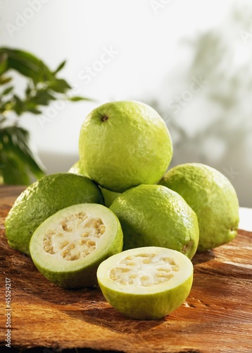 Photo: Several guavas on wooden board Several guavas on wooden board