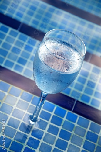 Photo: A glass of water by the pool A glass of water by the pool