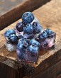 Ice cubes with blueberries on a wooden table