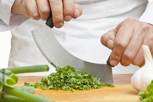 Photo: Chopping curly parsley with a mezzaluna knife Chopping curly parsley with a mezzaluna knife