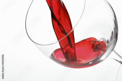 Photo: Red wine being poured into a glass Red wine being poured into a glass