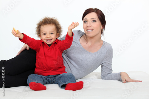 Photo: Toddler sat on the floor with mother Toddler sat on the floor with mother