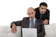 Smart executives sitting with a laptop