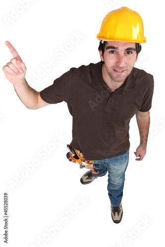 Photo: Builder pointing at copyspace Builder pointing at copyspace