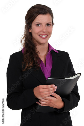 Photo: Young executive holding folder Young executive holding folder