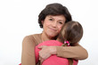 Woman hugging her granddaughter