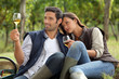 Couple sat tasting wine in vineyard