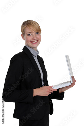 Photo: Businesswoman holding a white laptop Businesswoman holding a white laptop
