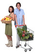 Market vs supermarket: Couple shopping for fruit and vegetables