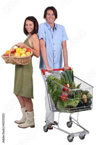 Photo: Market vs supermarket: Couple shopping for fruit and vegetables Market vs supermarket: Couple shopping for fruit and vegetables