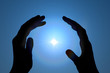 Hands protecting energy spark