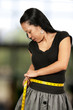 Hispanic Woman Measuring Her Waist