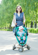Woman walking with baby stroller