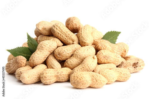 Photo: tasty peanuts with leaves, isolated on white tasty peanuts with leaves, isolated on white