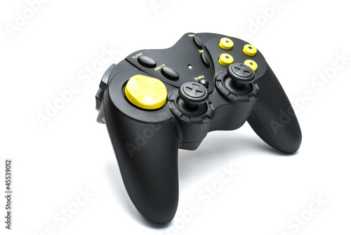 Photo: Black game controller with yellow buttons. Black game controller with yellow buttons.