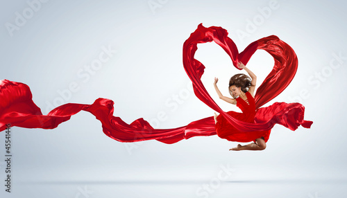 Photo: Dancing young woman with flying fabric Dancing young woman with flying fabric