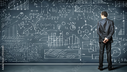 Photo: Business person against the blackboard Business person against the blackboard
