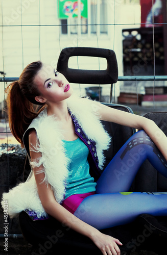 Photo: Teen modern fashion model girl sitting in studio Teen modern fashion model girl sitting in studio