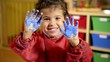 Happy children having fun and painting in kindergarten