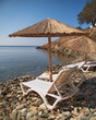 blue stairs to tranquil beach with umbrellas and chairs
