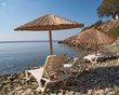 blue stairs to tranquil beach with umbrellas and chairs