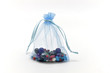 Blue cloth bag filled with glass beads for jewelry