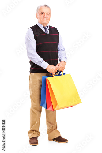 Photo: Full length portrait of a gentleman holding shopping bags Full length portrait of a gentleman holding shopping bags