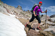 Photo: Hiking woman in mountains with snow, Corsica Hiking woman in mountains with snow, Corsica