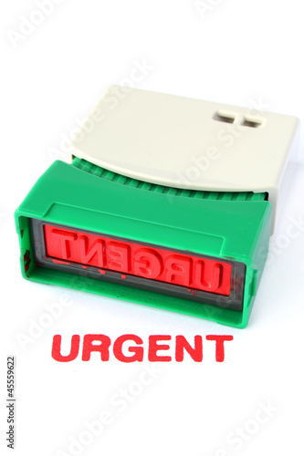 Photo: Urgent Ink stamper isolated on white background Urgent Ink stamper isolated on white background