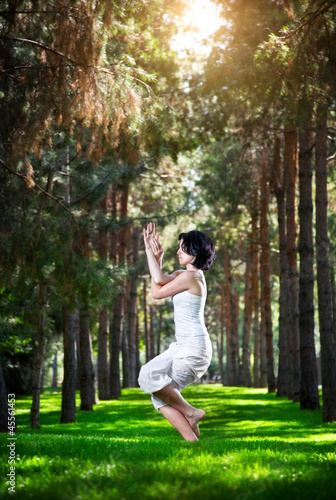 Photo: Yoga eagle pose in the park Yoga eagle pose in the park