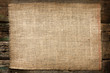 Burlap jute canvas vintage background on wooden boards