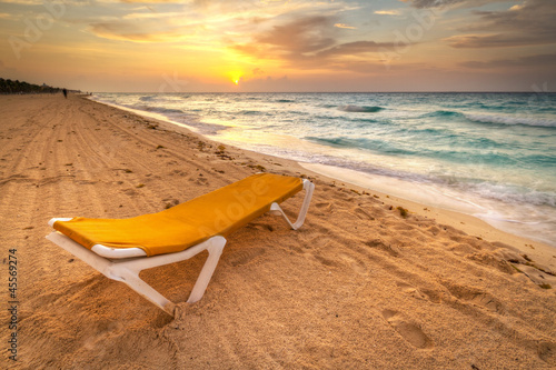 Photo: Yellow deckchair on the Caribbean Sea at sunrise Yellow deckchair on the Caribbean Sea at sunrise