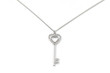 Photo: Silver key pendant necklace, Isolated on white Silver key pendant necklace, Isolated on white