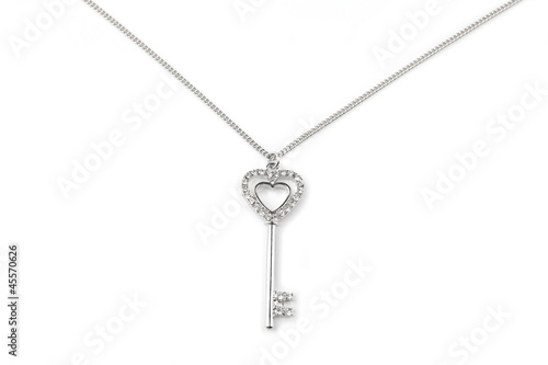 Photo: Silver key pendant necklace, Isolated on white Silver key pendant necklace, Isolated on white