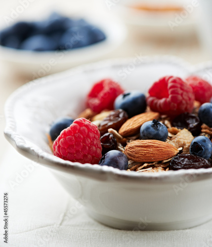 Photo: Bowl of granola with fresh fruits and almonds Bowl of granola with fresh fruits and almonds