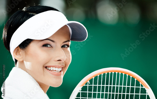 Photo: Close up of professional female tennis player with towel Close up of professional female tennis player with towel
