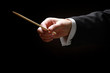 A concert conductor's hands with a baton