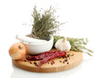 dried herbs in mortar and vegetables, isolatrd on white