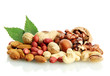 assortment of tasty nuts with leaves, isolated on white