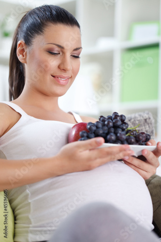 Photo: Pregnant woman with fruits Pregnant woman with fruits