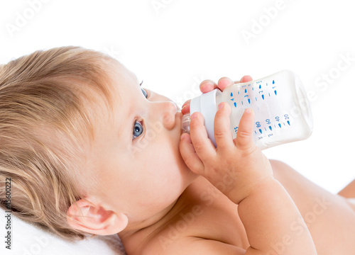 Photo: adorable child drinking from bottle adorable child drinking from bottle