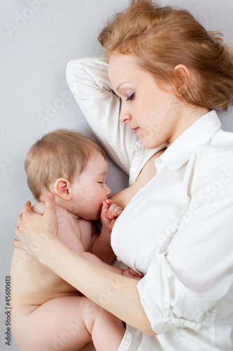 Photo: beautiful mother breast feeding her baby boy beautiful mother breast feeding her baby boy