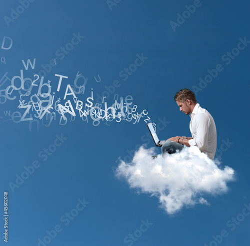 Photo: Businessman works over a cloud Businessman works over a cloud