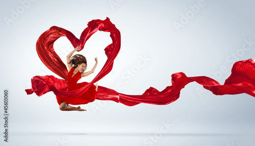 Photo: Dancing young woman with flying fabric Dancing young woman with flying fabric