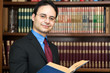 Businessman holding a book in his office