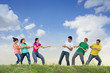 Group of young people pulling a rope