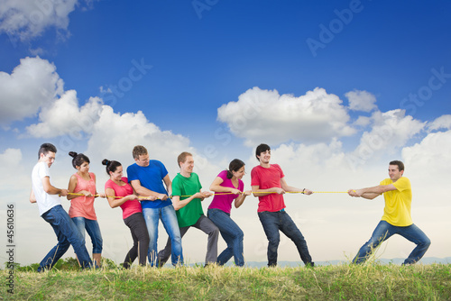 Photo: Group of young people pulling a rope Group of young people pulling a rope